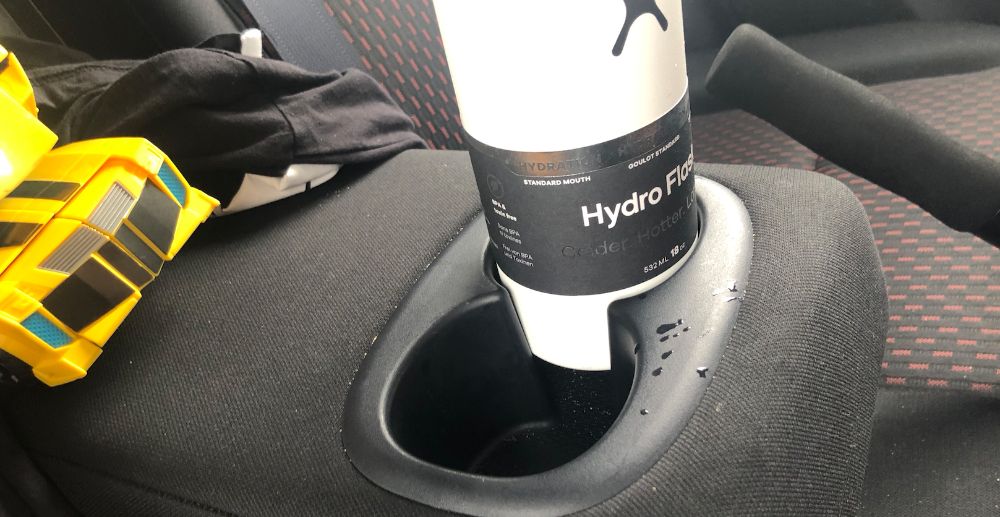 A large car cup holder, because this'll safely keep your Hydro Flask,  thermos, or other bigger bottles on-hand while driving. The days of  listening to your ther…