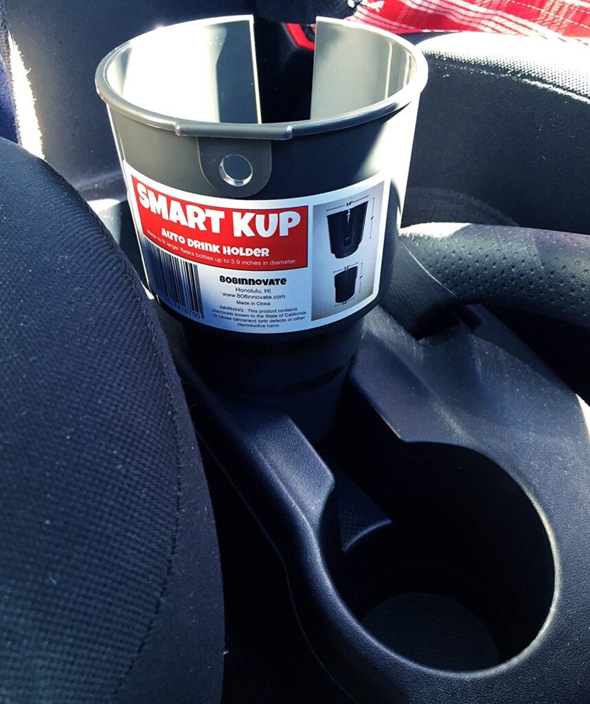 A large car cup holder, because this'll safely keep your Hydro Flask,  thermos, or other bigger bottles on-hand while driving. The days of  listening to your ther…