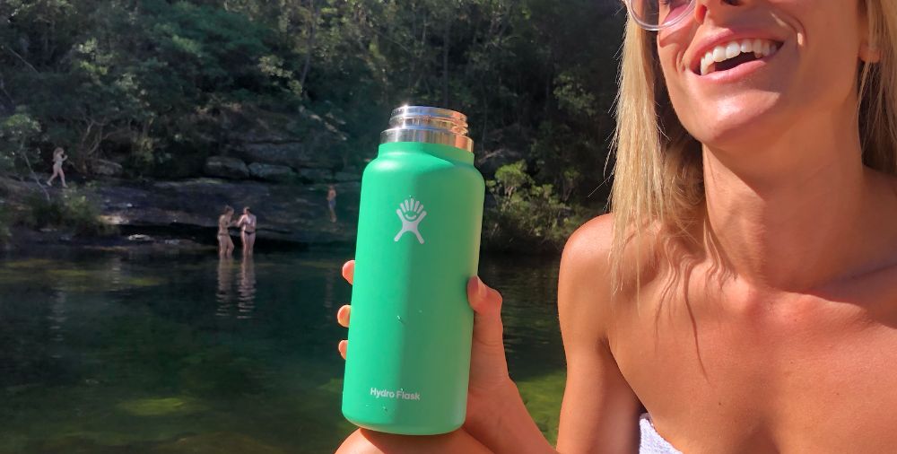 https://huntingwaterfalls.com/wp-content/uploads/2020/05/hydro-flask-32-oz-spearmint-green-attractive-girl-happy-sun-tan-smile.jpg