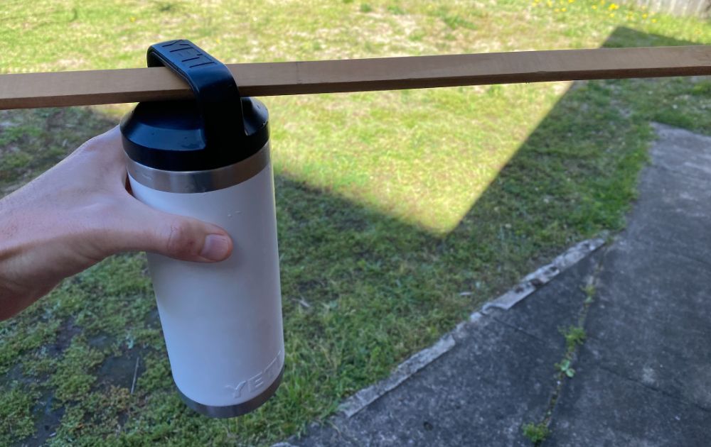 https://huntingwaterfalls.com/wp-content/uploads/2020/06/putting-a-stick-through-stuck-yeti-bottle-lid.jpg