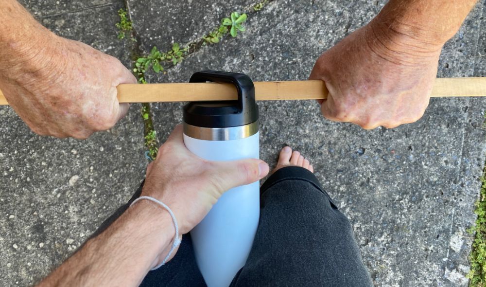 https://huntingwaterfalls.com/wp-content/uploads/2020/06/using-stick-as-lever-to-open-a-stuck-yeti-bottle-lid.jpg