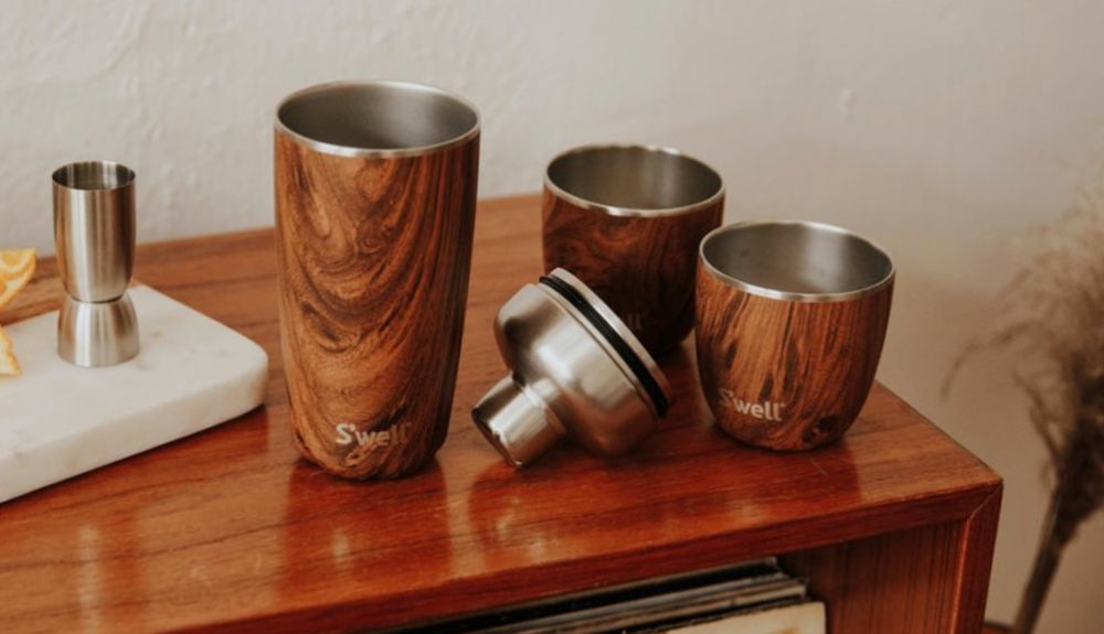 https://huntingwaterfalls.com/wp-content/uploads/2020/08/swell-tumbler-cup-on-table-wood-grain-finish.jpg