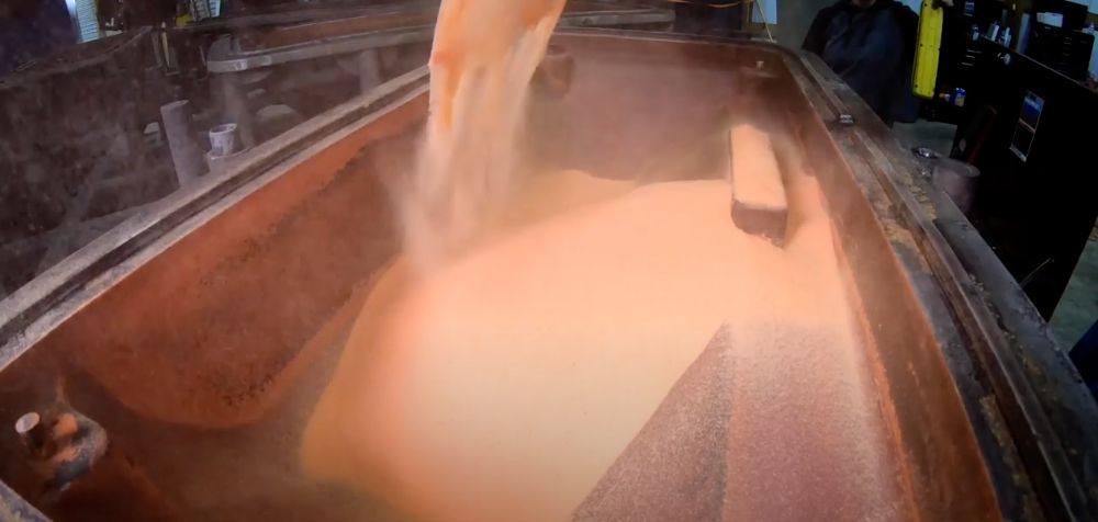 Plastic powder being poured into a roto-molding machine