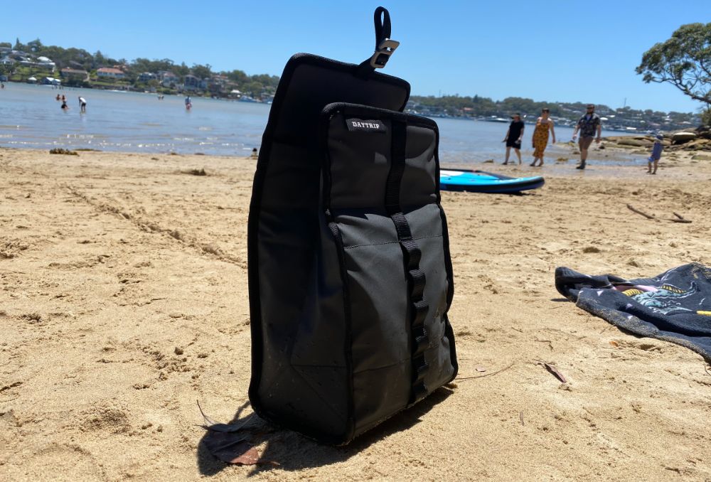 https://huntingwaterfalls.com/wp-content/uploads/2021/02/yeti-daytrip-cooler-bag-lunch-box-at-beach-open-upright.jpg