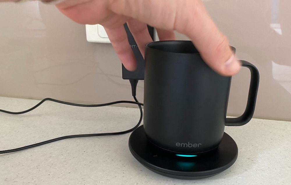 https://huntingwaterfalls.com/wp-content/uploads/2021/03/placing-ember-mug-on-charging-coaster-charger.jpg