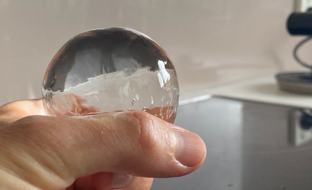 https://huntingwaterfalls.com/wp-content/uploads/2022/03/clear-ice-sphere-ball-in-hand.jpg