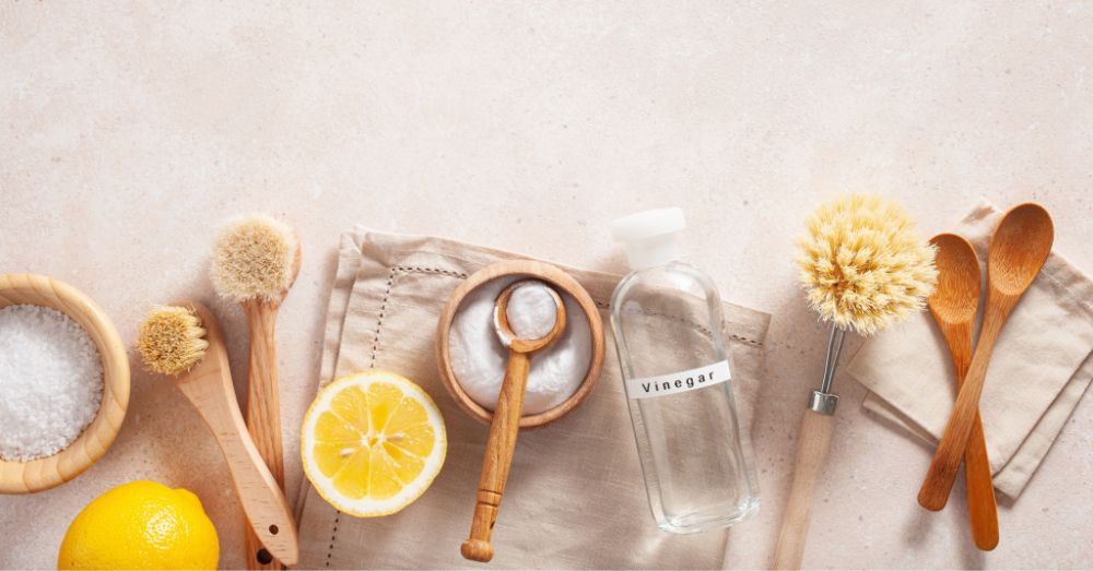 https://huntingwaterfalls.com/wp-content/uploads/2022/09/natural-cleaning-supplies-wood-baking-soda-vinegar-salt-lemon-brushes.jpg