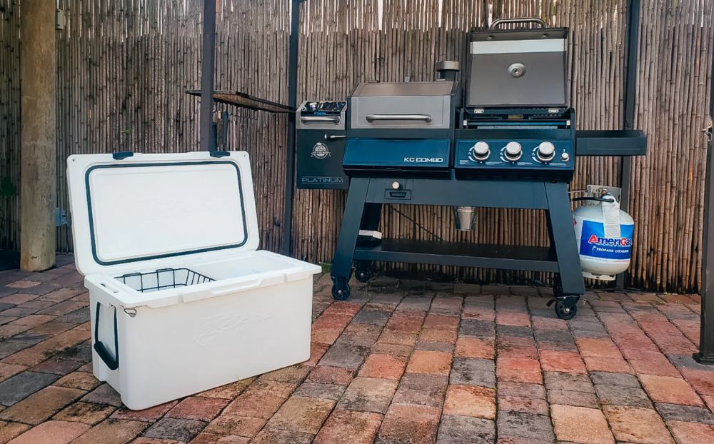 https://huntingwaterfalls.com/wp-content/uploads/2022/10/coho-55-quart-cooler-yeti-knockoff-at-costco-next-to-bbq.jpg